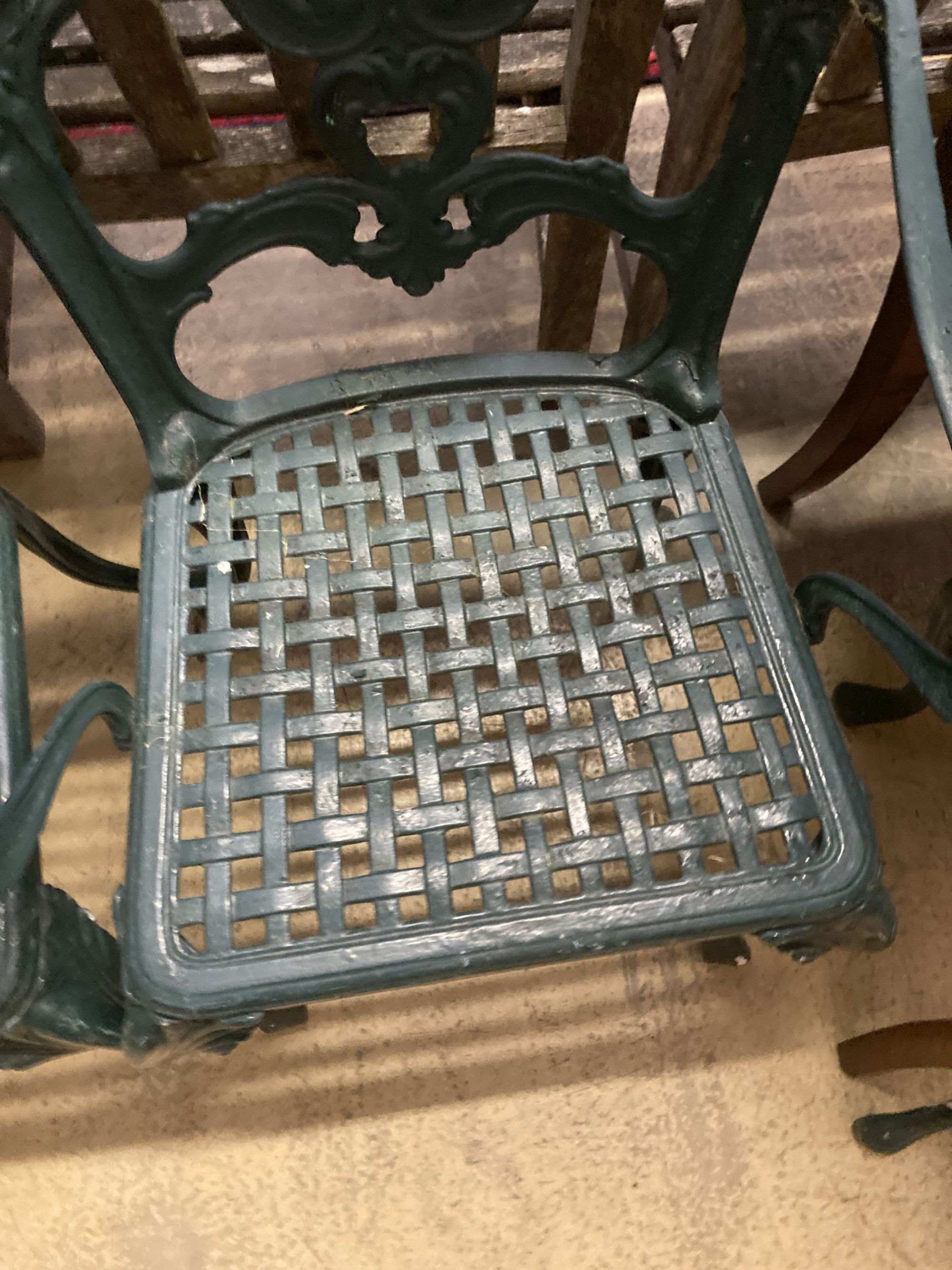 A set of four painted cast aluminium garden chairs (two with arms)